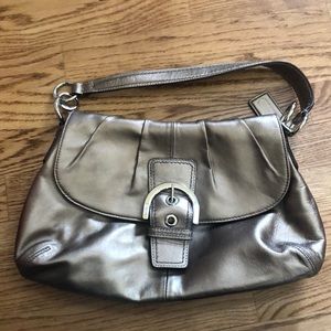Coach purse with belt buckle clasp